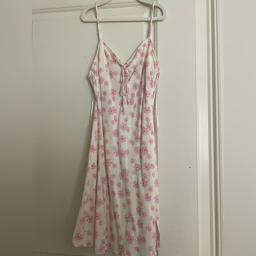 White mini dress with spaghetti strap and pink floral detail
